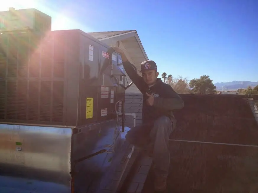 HVAC technician performing HVAC Inspection on a rooftop unit in Drexel Heights